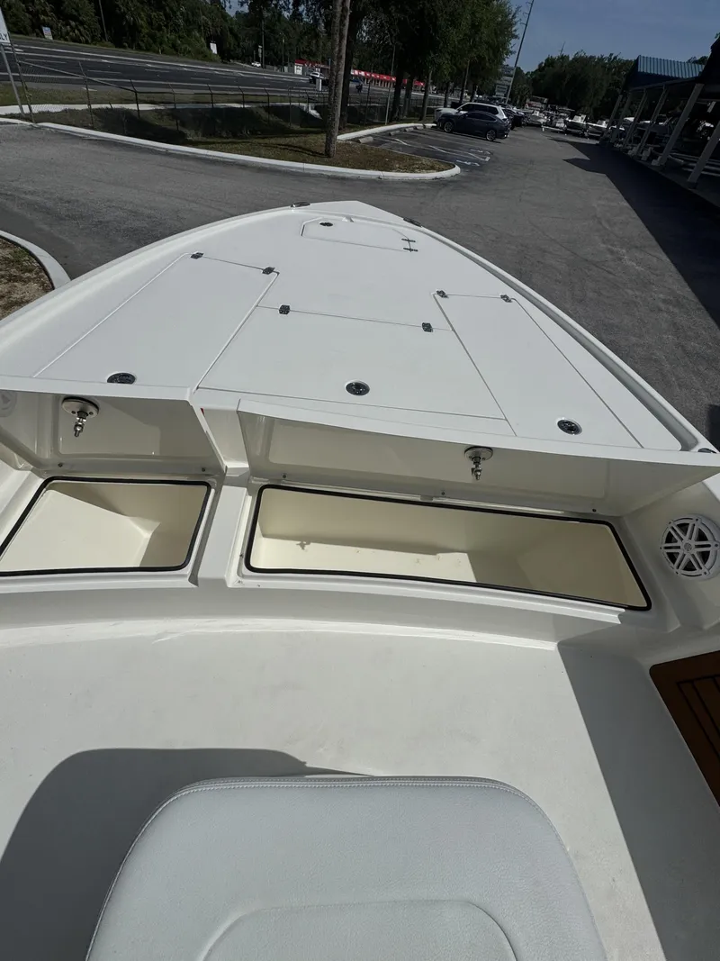 Slide: The Image of Pathfinder 2500 Hybrid 2026 boat with storage compartments and seating area. - 8