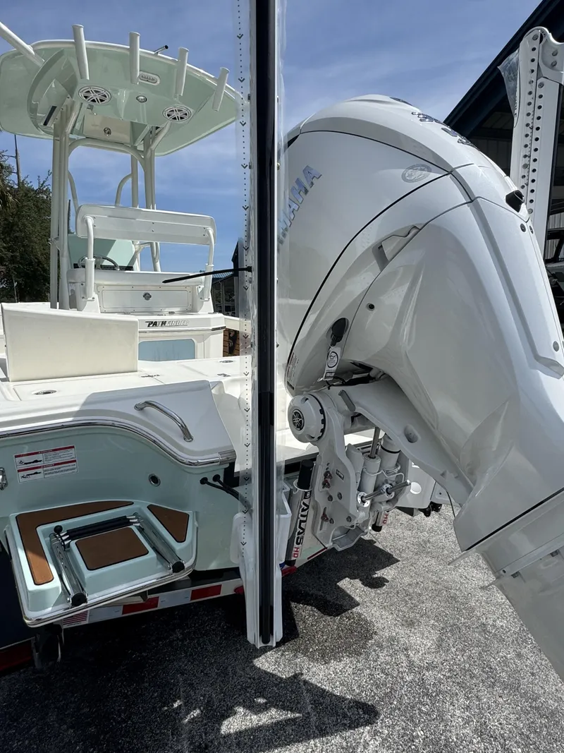 Slide: The Image of Pathfinder 2500 Hybrid 2026 with outboard motor, parked on trailer. - 9