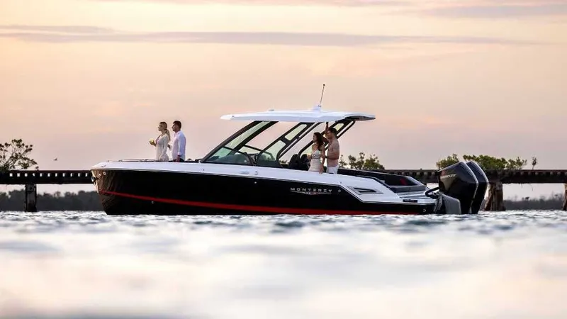 The Image of 2026 Monterey Elite 30 OB boat on water at sunset. - 0