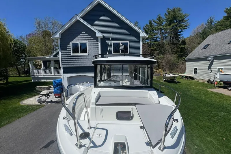 Slide: The Image of 2023 Jeanneau NC Sport 695 Series 2 boat parked in a residential driveway. - 10