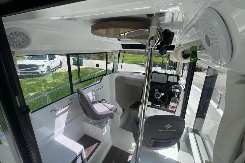 Slide: The Image of Interior of 2023 Jeanneau NC Sport 695 Series 2 boat, featuring helm and seating area. - 17