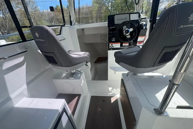 Slide: The Image of 2023 Jeanneau NC Sport 695 Series 2 boat interior with helm and seating. - 18