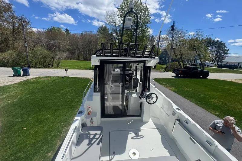 Slide: The Image of 2023 Jeanneau NC Sport 695 Series 2 boat on driveway, sunny day, green lawn. - 20