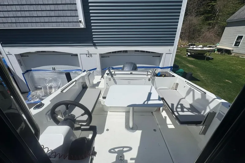 Slide: The Image of 2023 Jeanneau NC Sport 695 Series 2 boat interior with seating and steering wheel. - 22