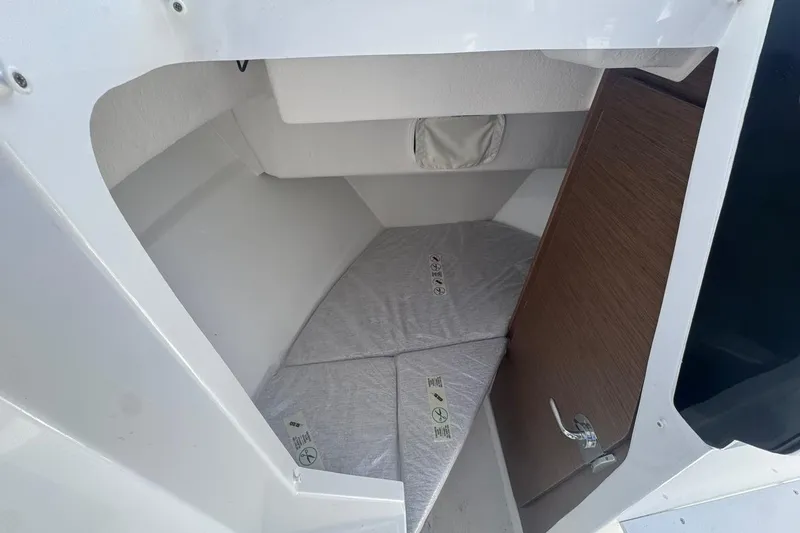 Slide: The Image of 2023 Jeanneau NC Sport 695 Series 2 cabin interior with bed and wooden door. - 24