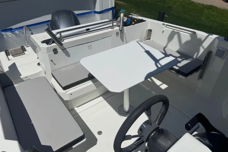 Slide: The Image of 2023 Jeanneau NC Sport 695 Series 2 boat interior with seating and table. - 25