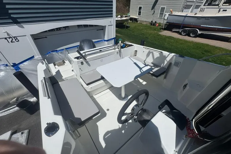 Slide: The Image of 2023 Jeanneau NC Sport 695 Series 2 boat interior with seating and steering wheel. - 26