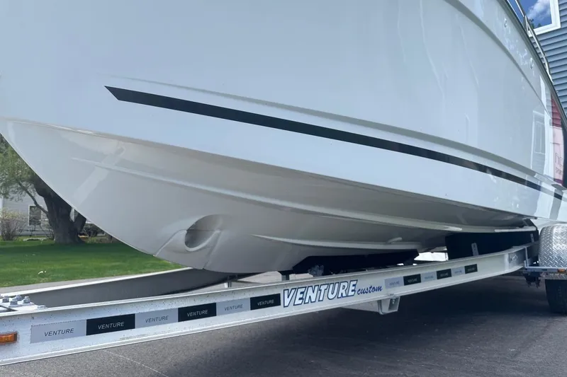 Slide: The Image of 2023 Jeanneau NC Sport 695 Series 2 boat on Venture trailer, side view. - 5