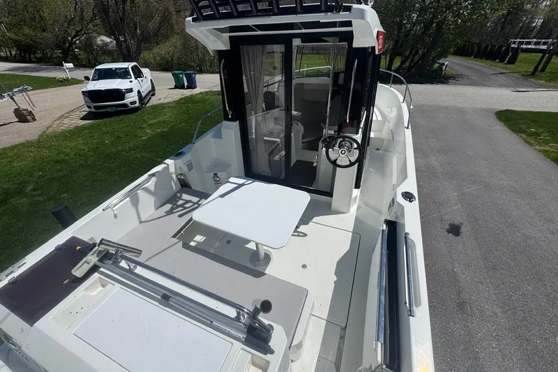 Slide: The Image of 2023 Jeanneau NC Sport 695 Series 2 boat with outdoor seating and steering wheel. - 8