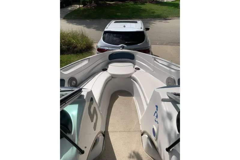 Slide: The Image of 2014 Four Winns 190 Horizon boat parked in driveway, viewed from bow. - 2