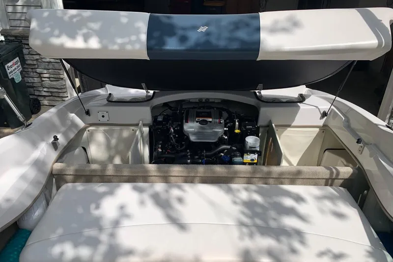 Slide: The Image of 2014 Four Winns 190 Horizon boat engine compartment with open hatch, showcasing engine details. - 3