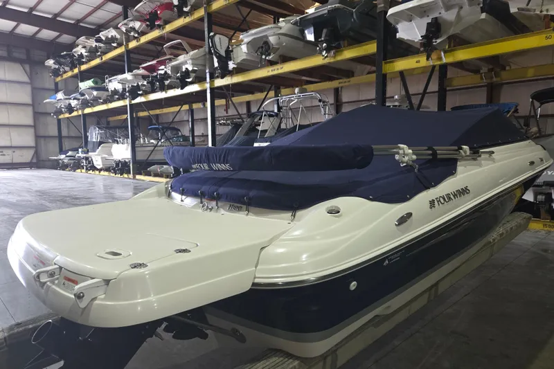Slide: The Image of 2014 Four Winns 190 Horizon boat in indoor storage facility, covered and secured. - 6