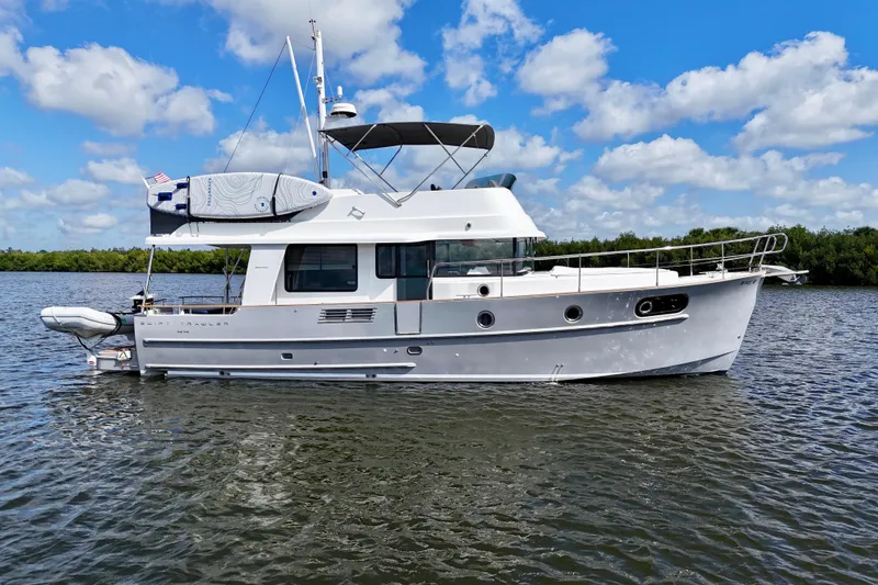 Slide: The Image of 2020 Beneteau Swift Trawler 44 on calm water under a blue sky. - 19