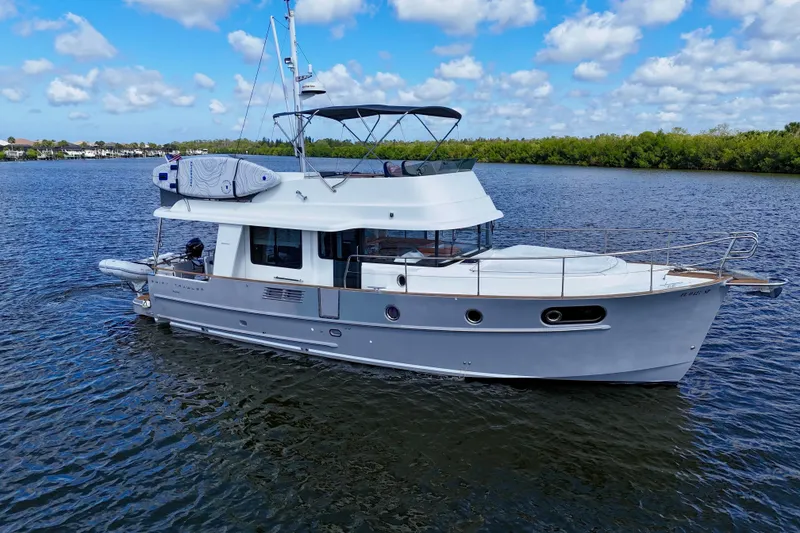 Slide: The Image of 2020 Beneteau Swift Trawler 44 cruising on a calm, scenic waterway. - 20