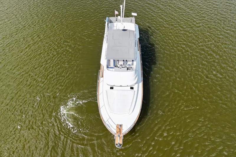 Slide: The Image of Aerial view of 2020 Beneteau Swift Trawler 44 cruising on calm water. - 22