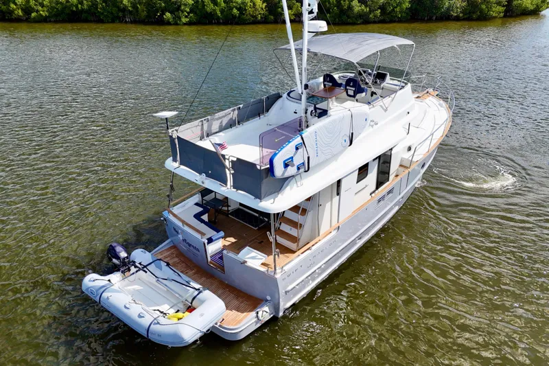 Slide: The Image of 2020 Beneteau Swift Trawler 44 cruising on calm waters, showcasing its elegant design. - 23