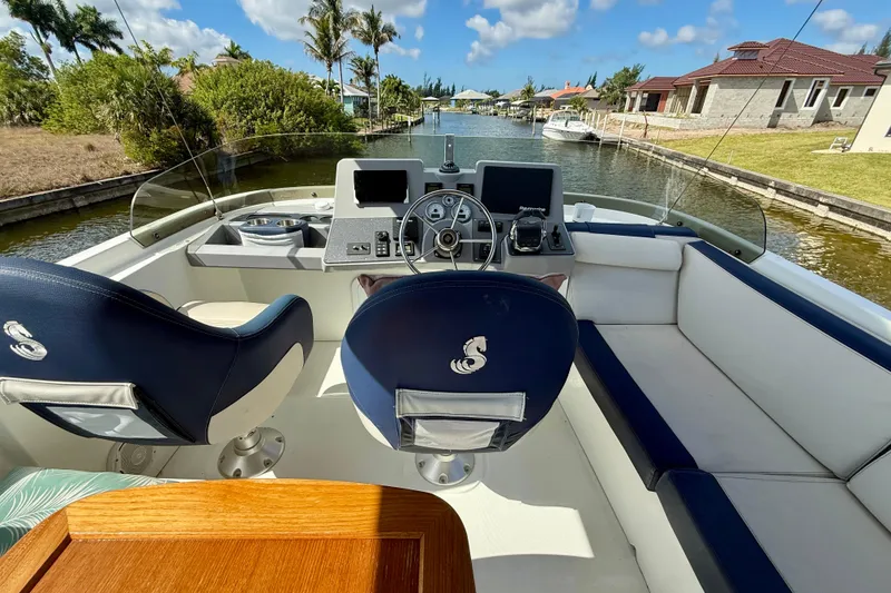 Slide: The Image of Cockpit view of 2020 Beneteau Swift Trawler 44, featuring helm and seating area. - 24
