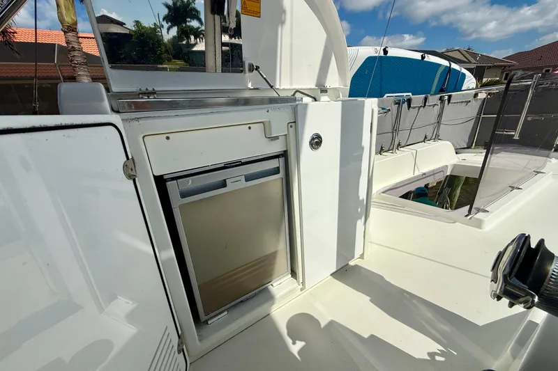 Slide: The Image of Beneteau Swift Trawler 44, 2020 model, featuring an outdoor kitchenette with a mini fridge. - 28