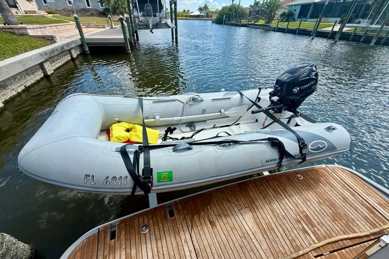 Slide: The Image of Inflatable dinghy with Tohatsu motor docked near Beneteau Swift Trawler 44, 2020 model. - 30