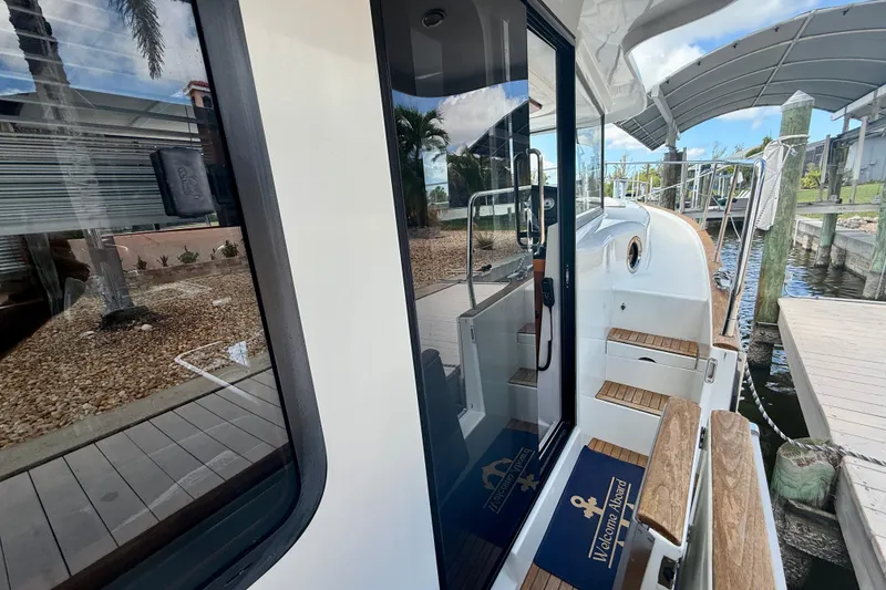 Slide: The Image of 2020 Beneteau Swift Trawler 44 docked, showcasing sleek design and wooden accents. - 32