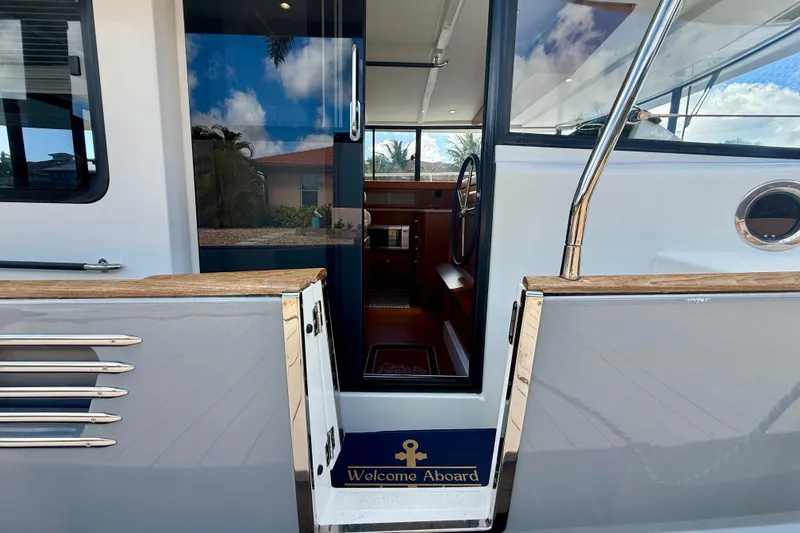 Slide: The Image of Entrance of 2020 Beneteau Swift Trawler 44 with "Welcome Aboard" sign. - 33