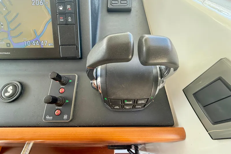 Slide: The Image of Control panel of a 2020 Beneteau Swift Trawler 44 with navigation and throttle controls. - 38