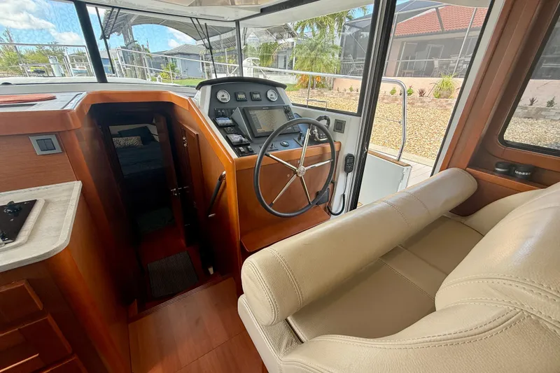 Slide: The Image of Interior view of 2020 Beneteau Swift Trawler 44 helm with steering wheel and navigation equipment. - 39