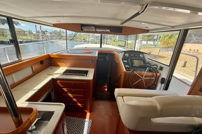 Slide: The Image of Interior view of 2020 Beneteau Swift Trawler 44, featuring helm and kitchen area. - 42
