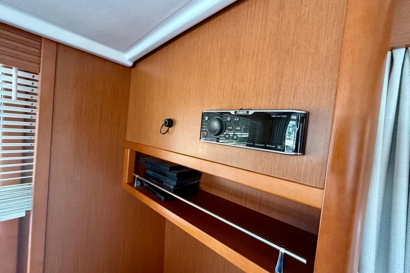 Slide: The Image of Interior of 2020 Beneteau Swift Trawler 44 with Fusion stereo system and wooden paneling. - 45