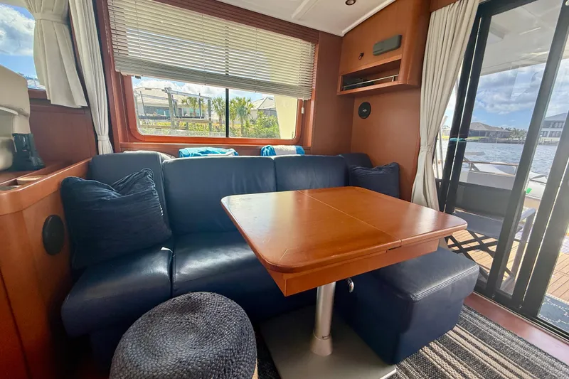 Slide: The Image of Interior of 2020 Beneteau Swift Trawler 44 with cozy seating and wooden table. - 49