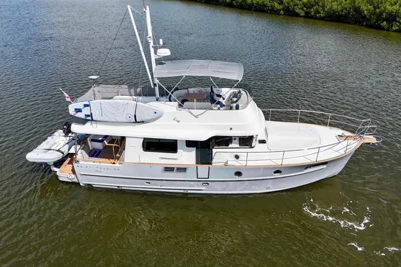 Slide: The Image of 2020 Beneteau Swift Trawler 44 cruising on calm waters, featuring a sleek design. - 5