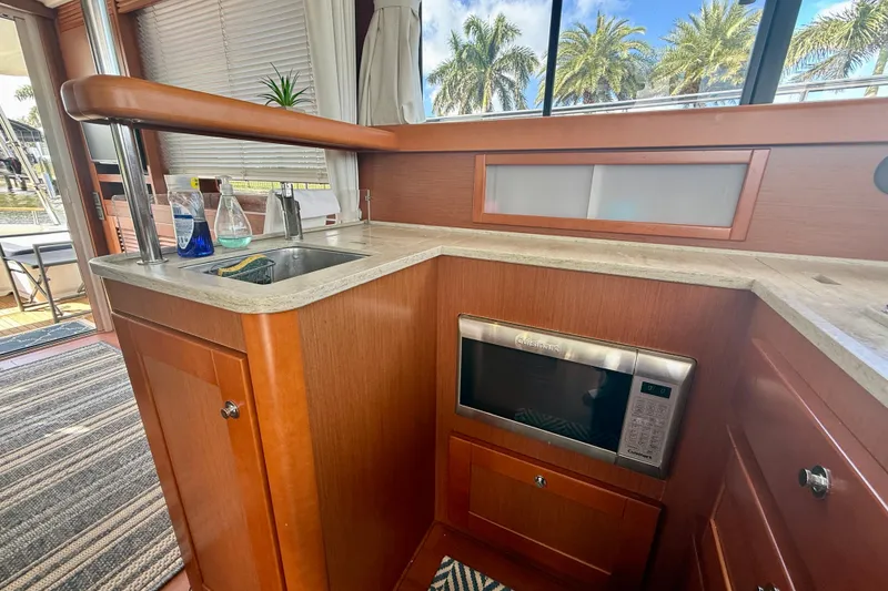 Slide: The Image of Interior of 2020 Beneteau Swift Trawler 44 kitchen with sink and microwave. - 51