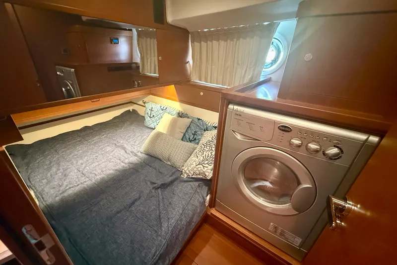 Slide: The Image of Cozy cabin with bed and washing machine in 2020 Beneteau Swift Trawler 44. - 53