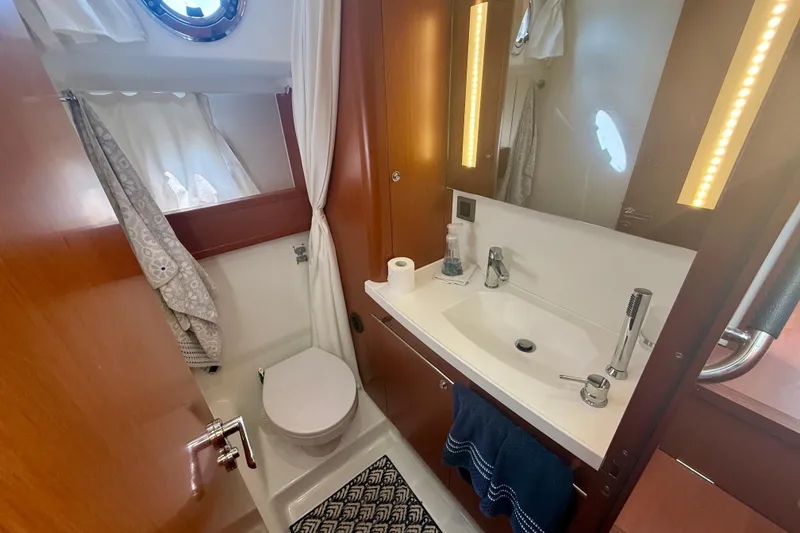 Slide: The Image of Bathroom interior of 2020 Beneteau Swift Trawler 44, featuring modern fixtures and wooden accents. - 55