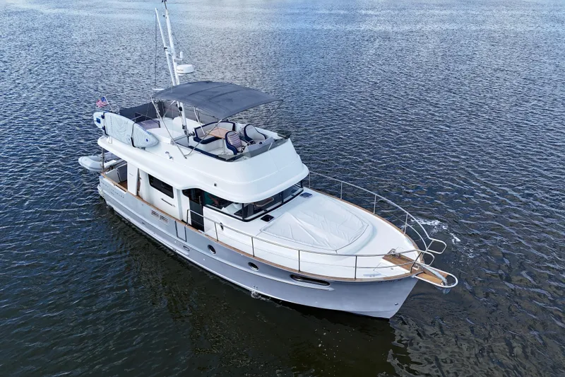 Slide: The Image of 2020 Beneteau Swift Trawler 44 cruising on calm waters, showcasing elegant design and spacious deck. - 7