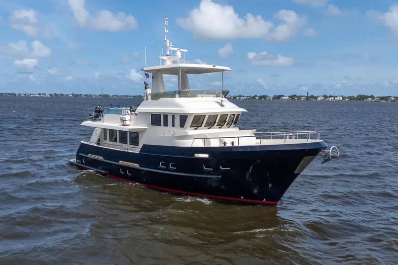 The Image of Luxurious 2022 Alm Trawler Delfino 64 yacht cruising on open water. - 1