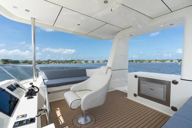 Slide: The Image of Luxurious 2022 Alm Trawler Delfino 64 yacht deck with seating and scenic water view. - 14