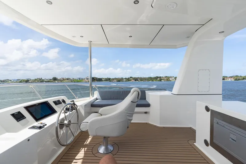 Slide: The Image of Helm of 2022 Alm Trawler Delfino 64 with modern controls and scenic water view. - 15