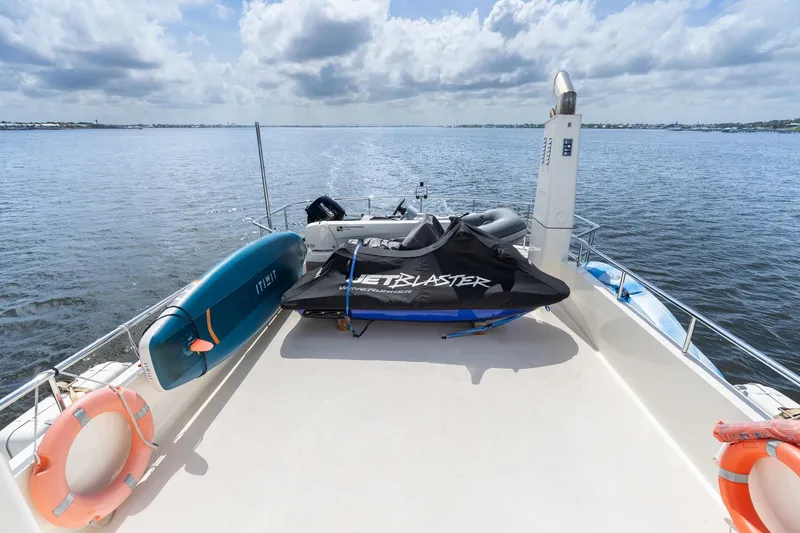 Slide: The Image of Deck of 2022 Alm Trawler Delfino 64 with watercraft and paddleboard. - 19
