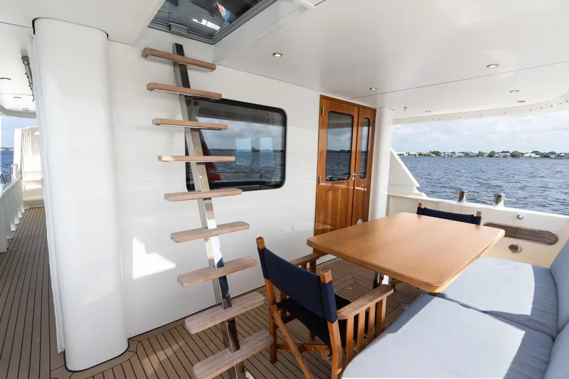 Slide: The Image of Luxurious 2022 Alm Trawler Delfino 64 yacht deck with seating and ladder. - 30