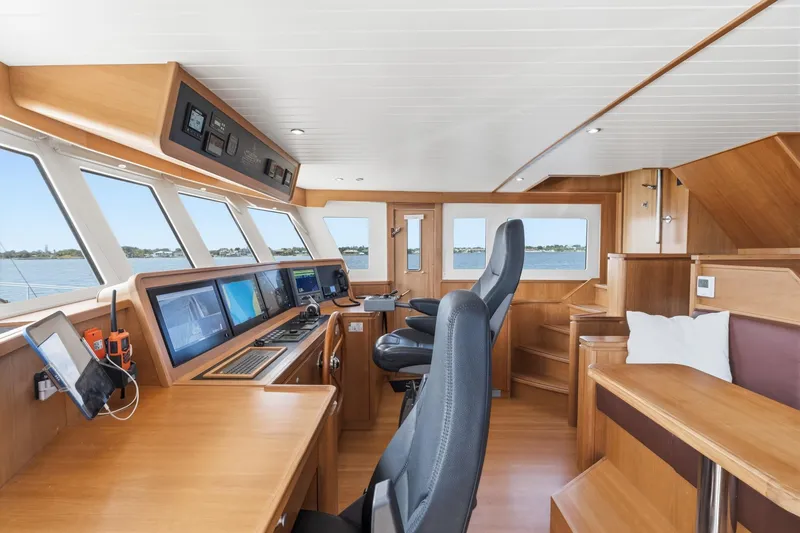 Slide: The Image of Pilothouse of 2022 Alm Trawler Delfino 64 with modern navigation equipment and wooden interior. - 33