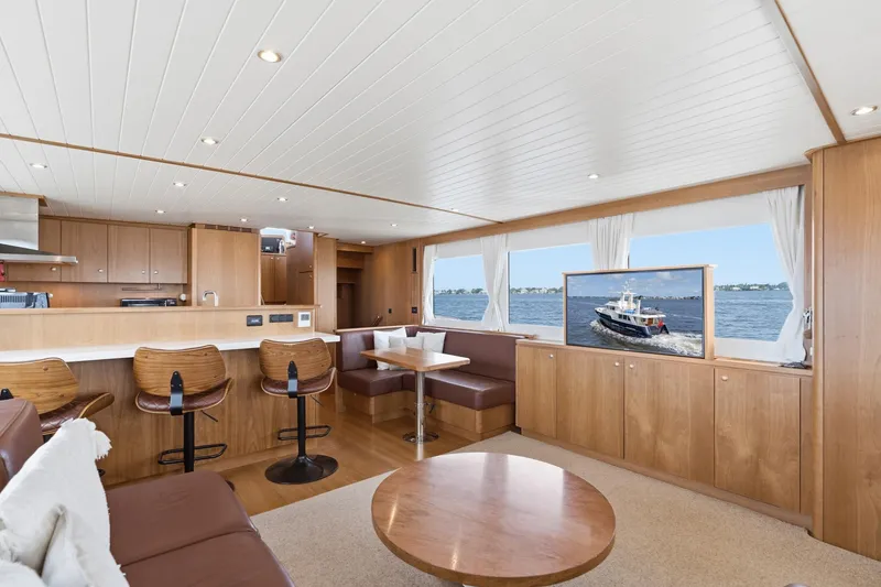 Slide: The Image of Luxurious interior of 2022 Alm Trawler Delfino 64 yacht with modern furnishings and scenic ocean view. - 34