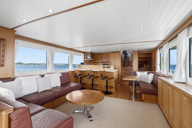 Slide: The Image of Luxurious interior of 2022 Alm Trawler Delfino 64 yacht with modern furnishings and panoramic windows. - 41