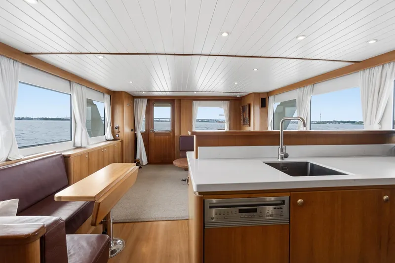 Slide: The Image of Interior of 2022 Alm Trawler Delfino 64 yacht with modern kitchen and seating area. - 44
