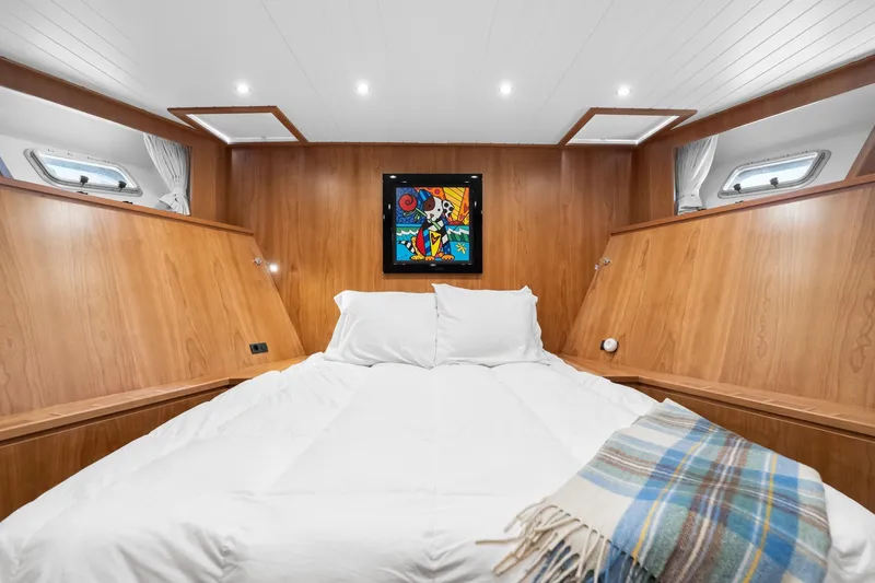 Slide: The Image of Luxurious cabin interior of 2022 Alm Trawler Delfino 64 with cozy bed and artwork. - 60