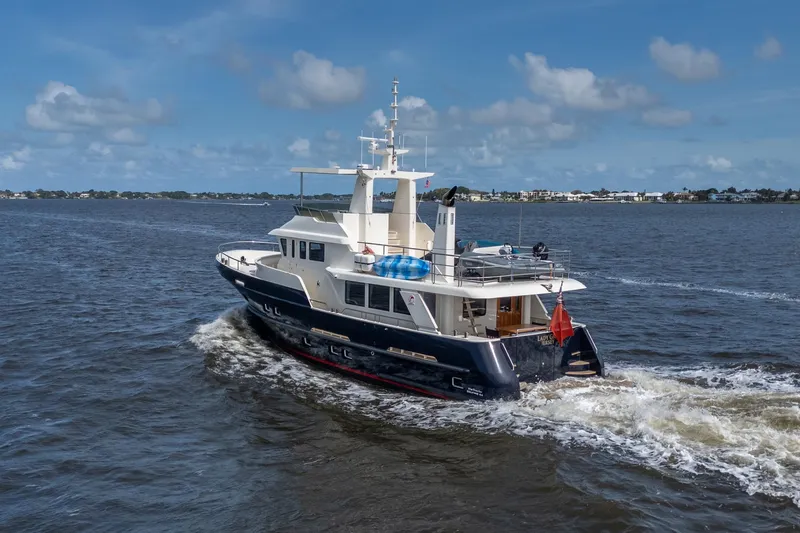 Slide: The Image of 2022 Alm Trawler Delfino 64 cruising on open water under a clear blue sky. - 9