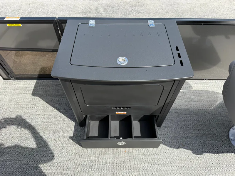 Slide: The Image of Barletta Aria 22F 2026 boat console with storage and measurement scale. - 14