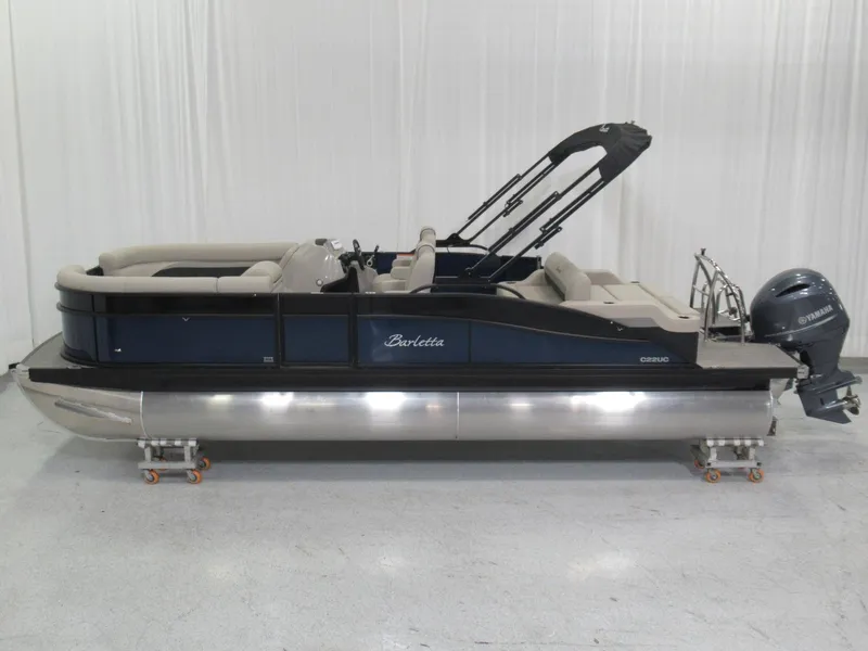 The Image of A 2020 Barletta C22UC pontoon boat with a blue hull and beige interior. - 1