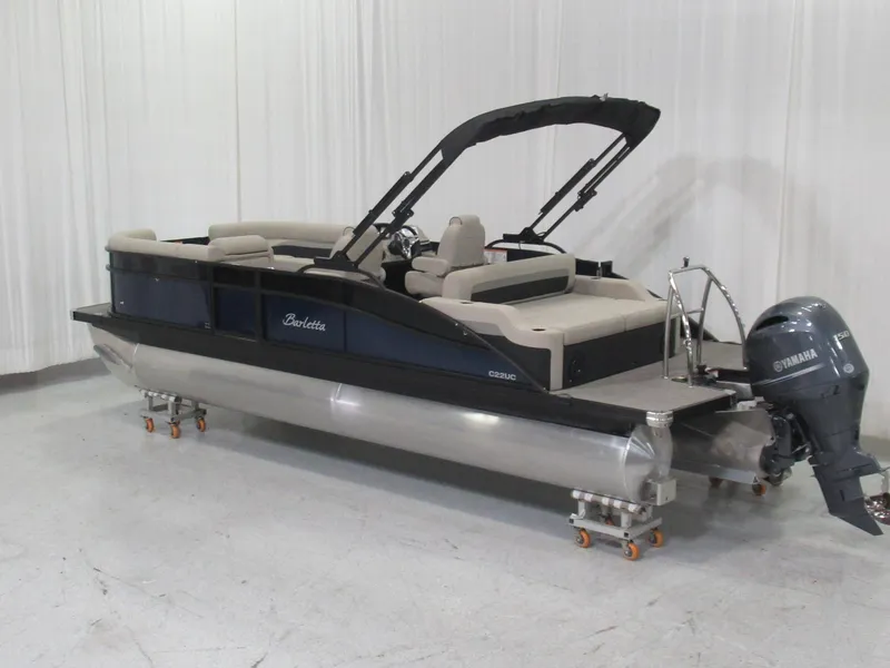 Slide: The Image of 2020 Barletta C22UC pontoon boat with Yamaha outboard motor, black hull, and beige interior. - 2