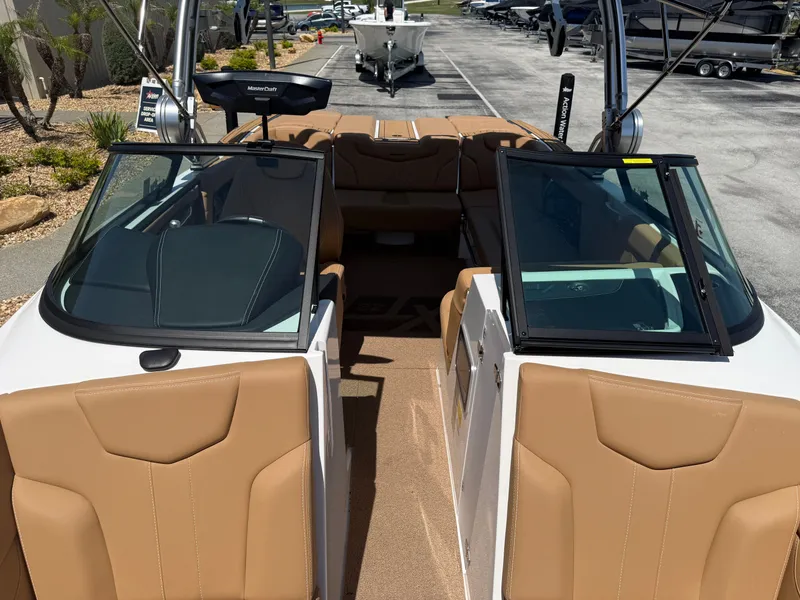 Slide: The Image of Interior view of a 2022 MasterCraft XT22 boat with brown seats. - 11